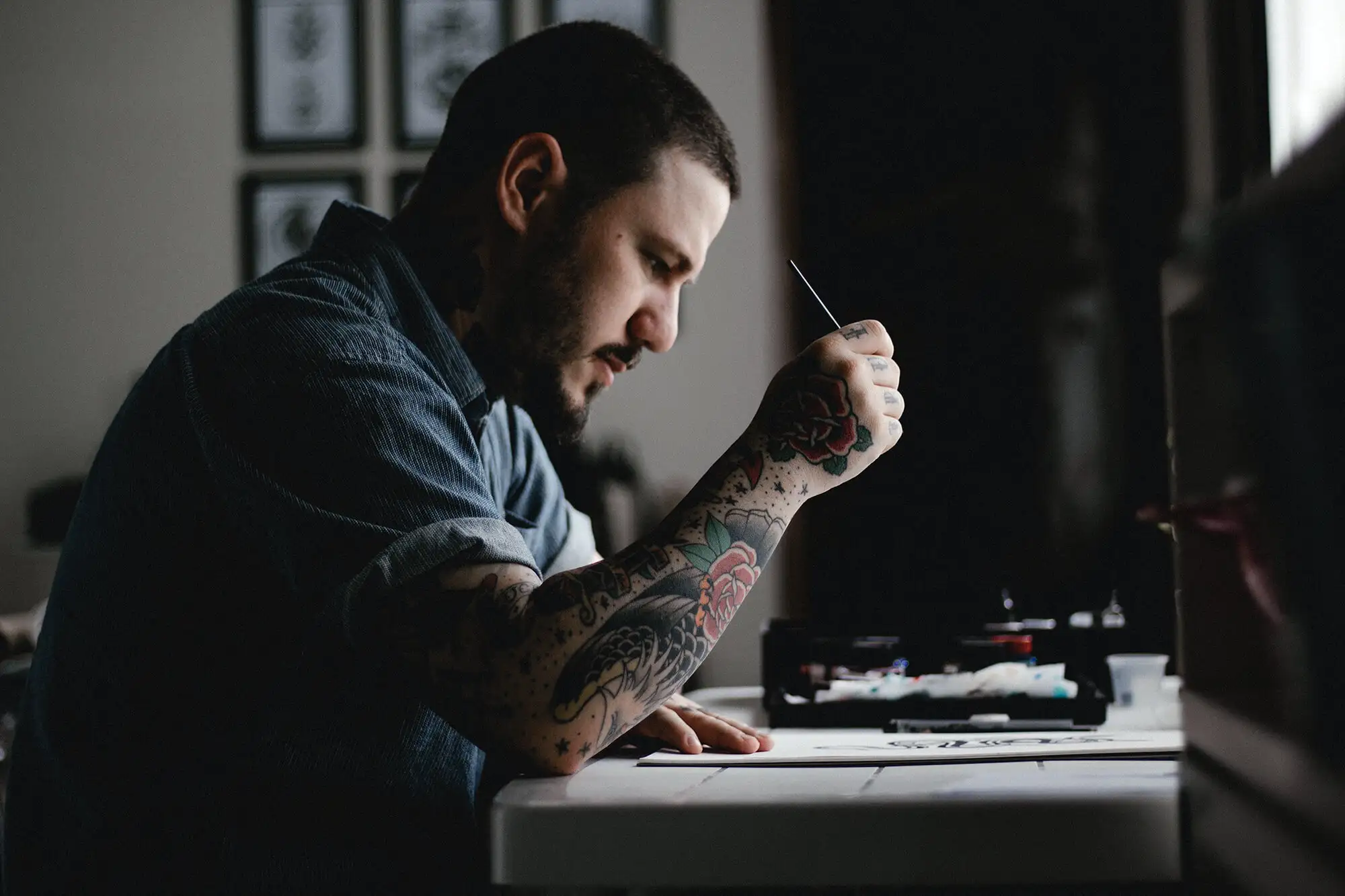 Man sitting at a desk writing on a piece of paper