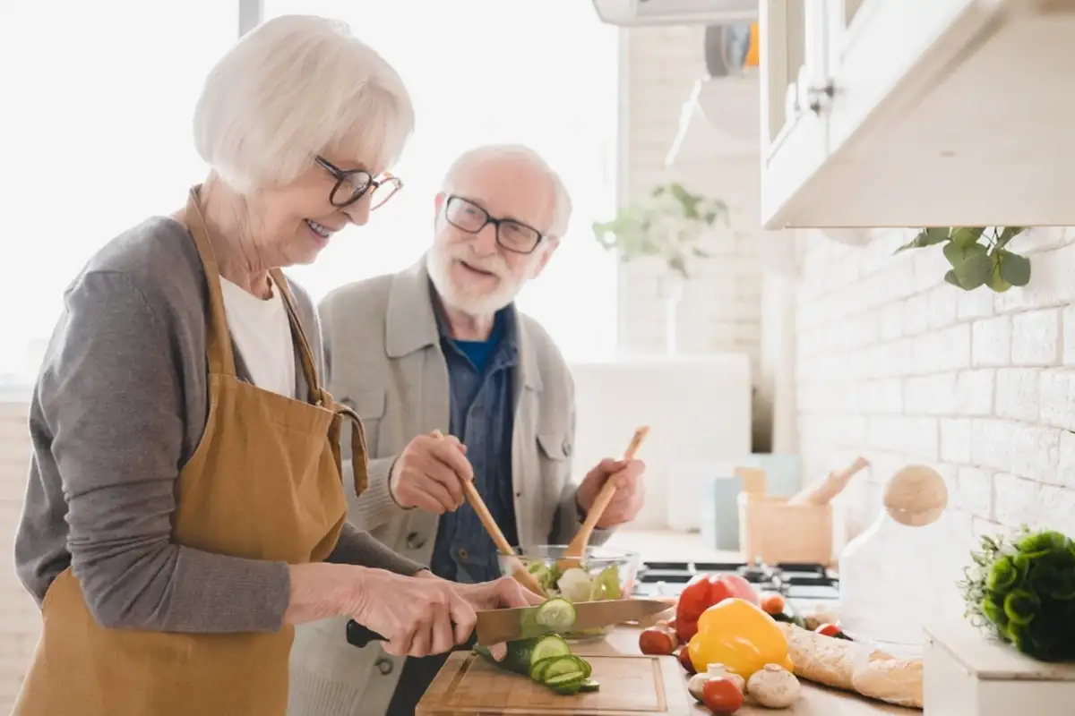 elderly couple cooking in the kitchen