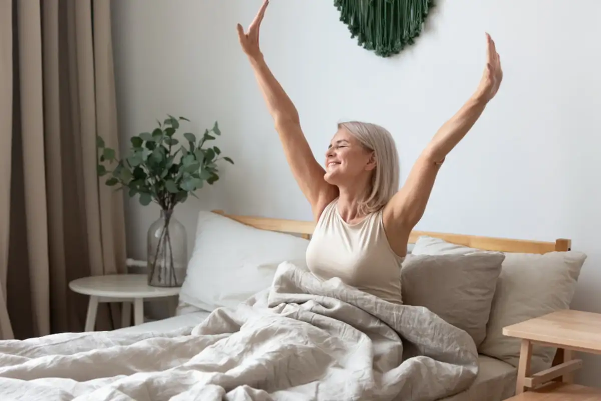 woman waking up and stretching