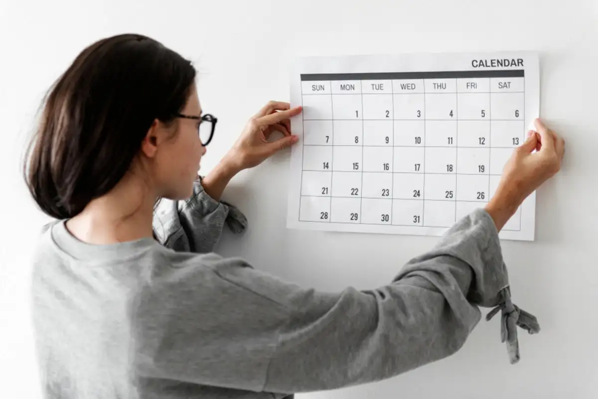 young woman looking at a calendar