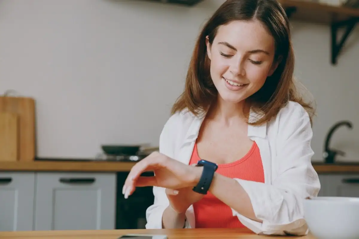 young woman looking at her watch