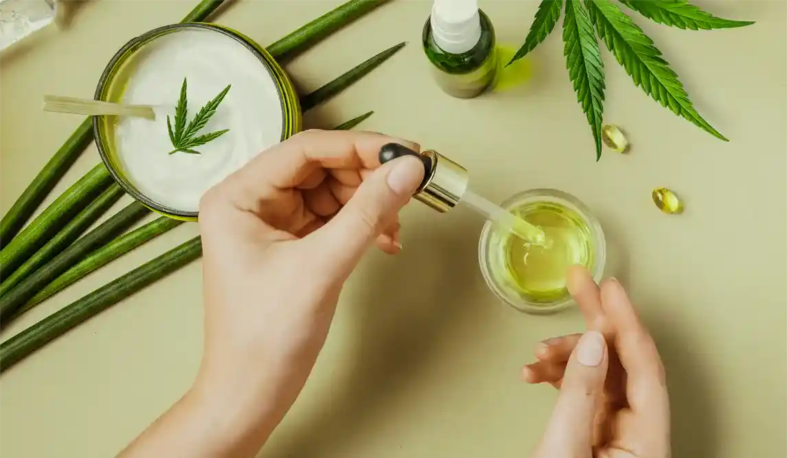 Close up of a hand handling cannabis tinctures