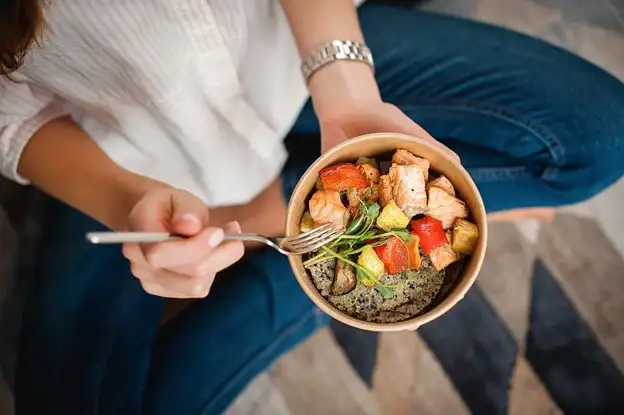 Woman eating food bowl