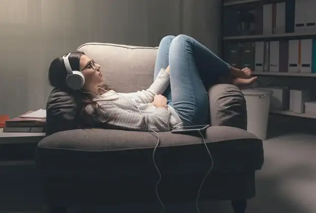 Woman on a sofa listening to music