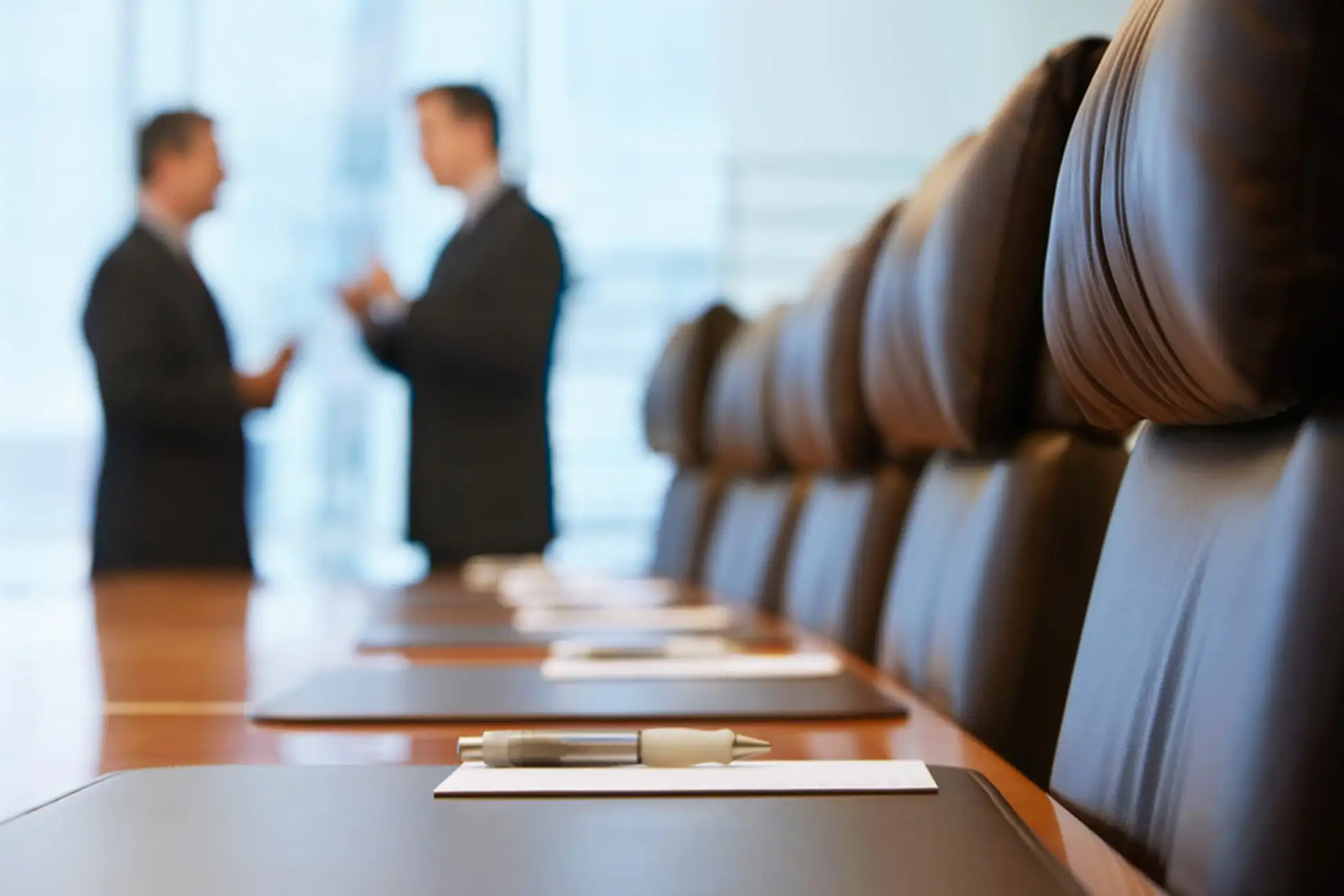 two business men talking in a meeting room